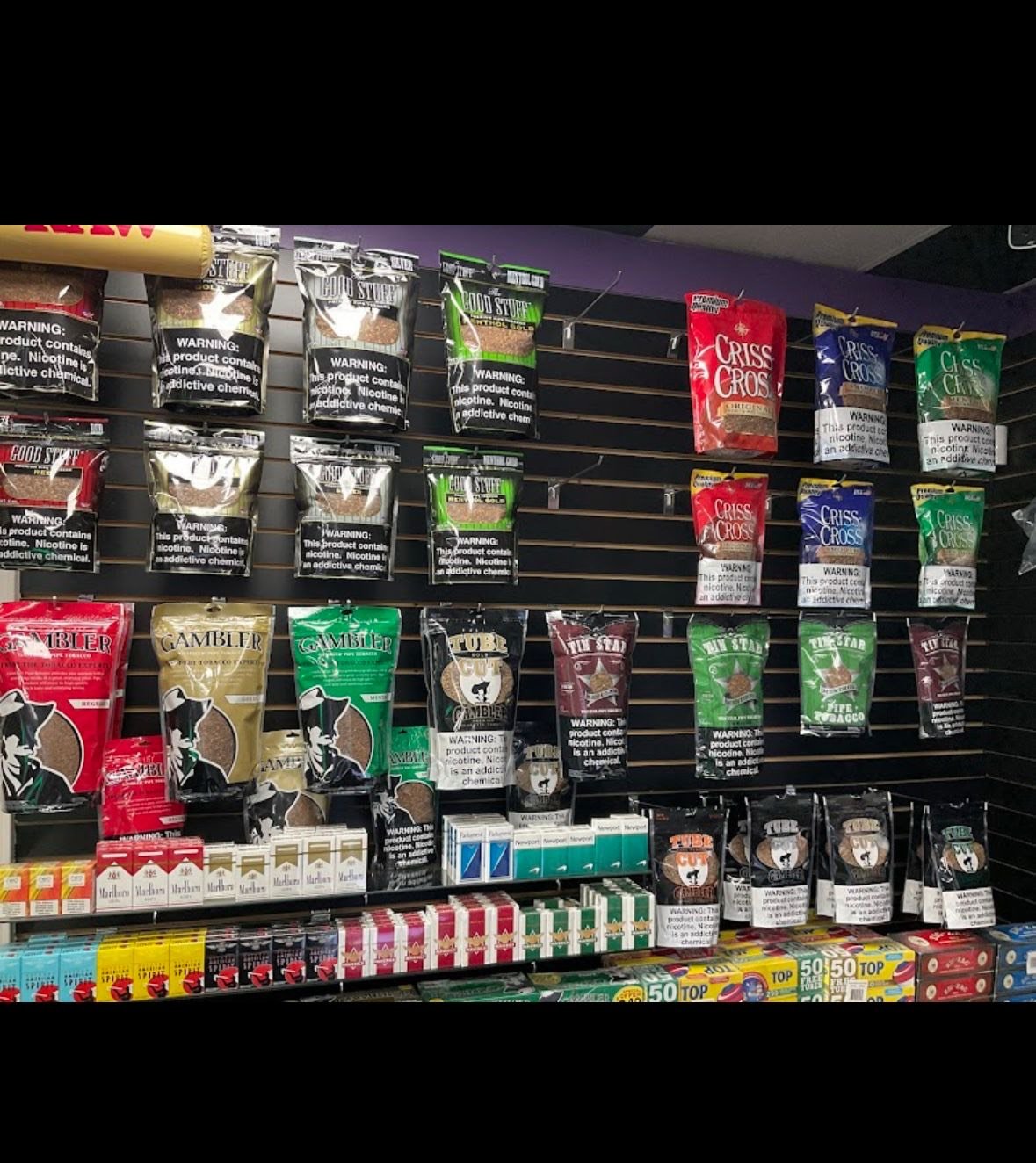 Tobacco and nicotine products displayed on shelves with warning labels