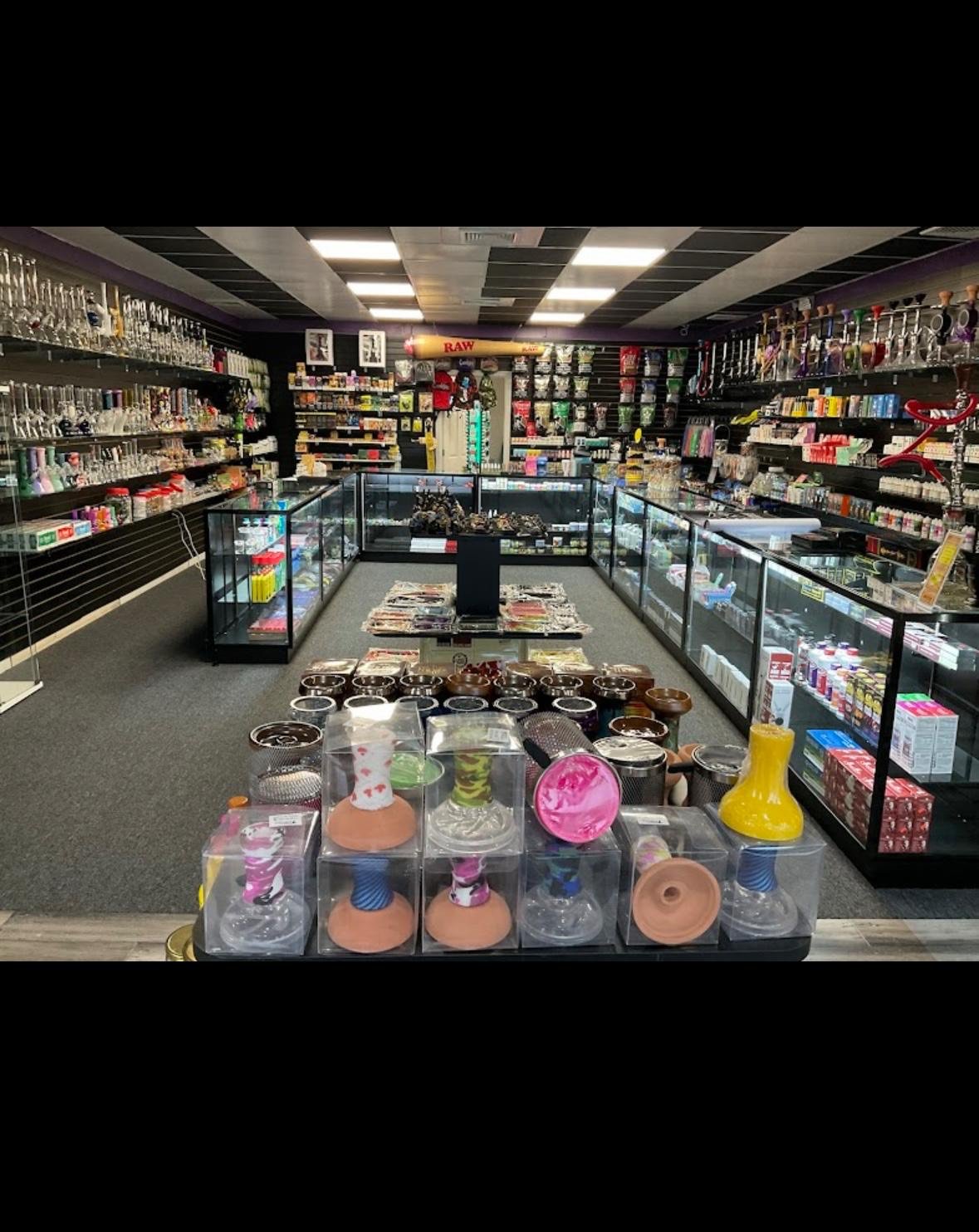 Smoke shop interior with glass display cases and colorful smoking accessories