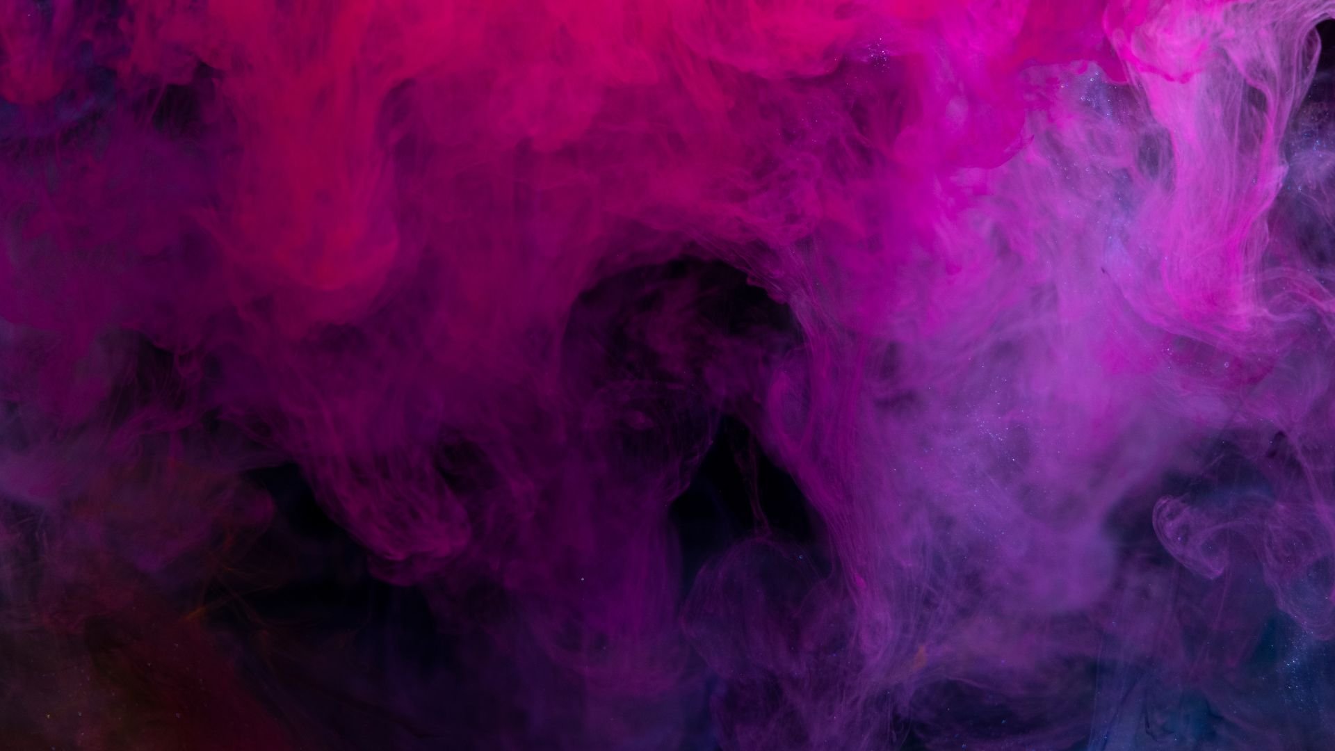 Swirling purple and pink smoke creating an abstract, ethereal texture