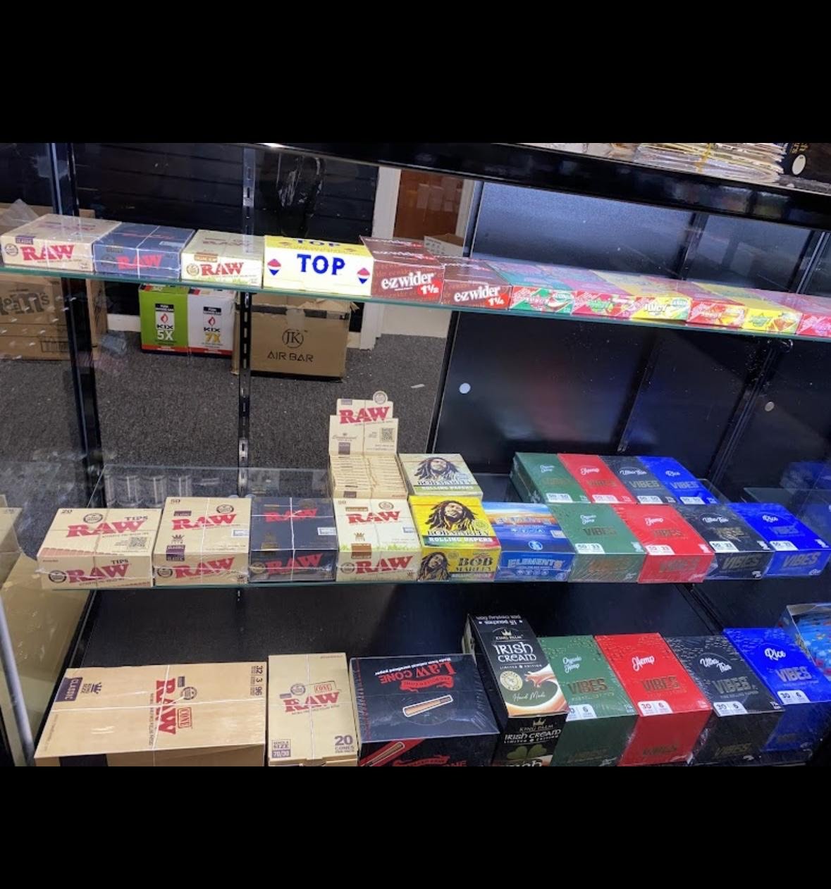 Shelves with various rolling papers, cigarette tubes, and smoking accessories